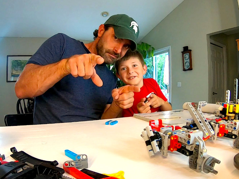 Kyle and Robert pointing at the camera while building the Six-Wheel Truck