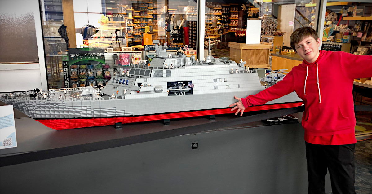 Kyle and ship 2 Professional LEGO Designer - USS Cleveland on display at the Great Lakes Science Center